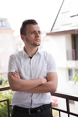 Image showing man standing at balcony