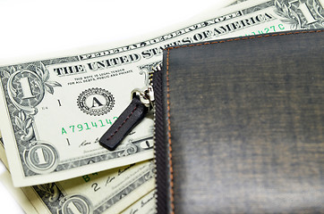 Image showing Money sticking out of a leather wallet