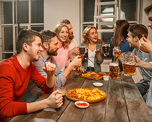 Image showing Group of friends enjoying evening drinks with beer