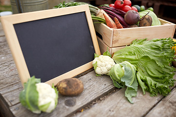 Image showing close up of vegetables with chalkboard on farm