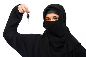 Image showing muslim woman in hijab with car key over white