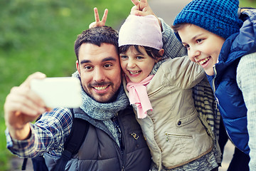 Image showing family taking selfie with smartphone outdoors