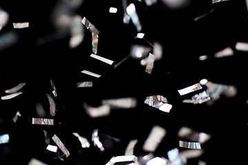 Image showing silver confetti over black background