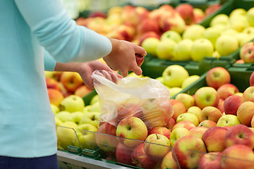 Image showing woman with bag buying apples at grocery store