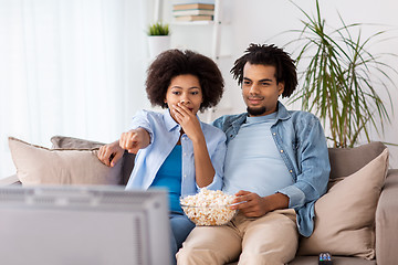 Image showing couple with popcorn watching tv at home
