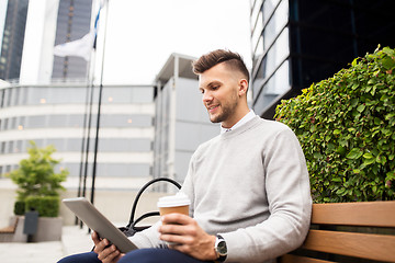 Image showing man with tablet pc and coffee on city street bench