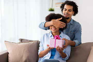 Image showing happy couple with gift box at home