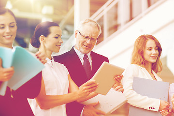 Image showing business team with tablet pc and folders at office