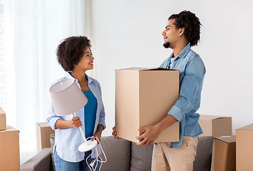 Image showing happy couple with stuff moving to new home