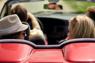 Image showing happy friends driving in convertible car at summer