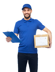 Image showing happy delivery man with parcel box and clipboard