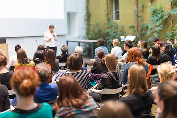 Image showing Woman giving presentation in lecture hall at university.