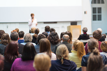 Image showing Woman giving presentation in lecture hall at university.