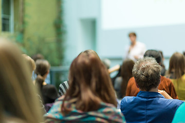 Image showing Woman giving presentation in lecture hall at university.