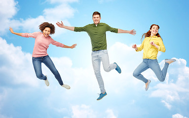 Image showing smiling young man jumping in air