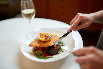 Image showing woman eating fish salad at cafe or restaurant