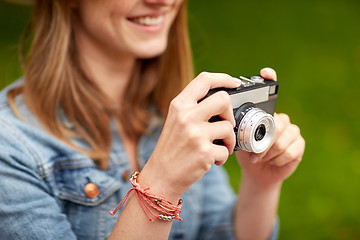 Image showing close up of woman with camera shooting outdoors