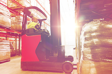 Image showing man on forklift loading cargo at warehouse