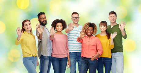 Image showing international group of happy people waving hand