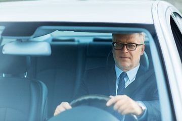 Image showing happy senior businessman driving car