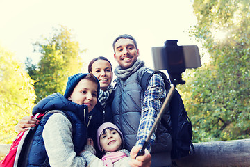 Image showing family with backpacks taking selfie and hiking