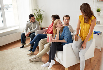 Image showing happy friends with popcorn and beer at home