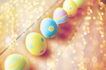 Image showing close up of colored easter eggs on wooden surface