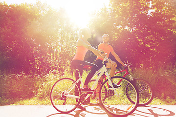 Image showing happy couple riding bicycle outdoors