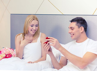 Image showing man giving woman little red box and ring in it