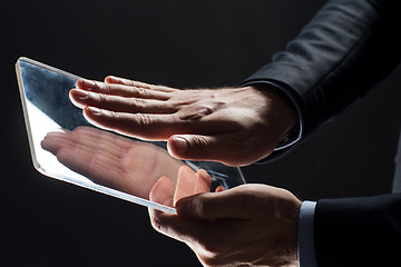 Image showing close up of businessman with transparent tablet pc