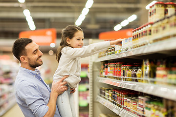 Image showing father with child buying food at grocery store