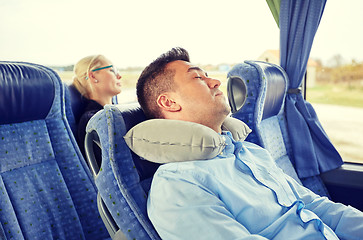 Image showing man sleeping in travel bus with cervical pillow