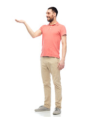 Image showing happy man holding something imaginary on hand