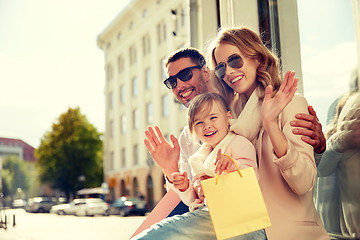 Image showing happy family with child and shopping bags in city