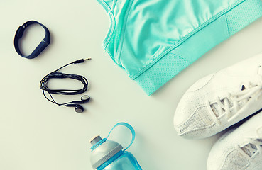 Image showing sportswear, bracelet, earphones and bottle set