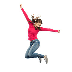 Image showing smiling young woman jumping in air