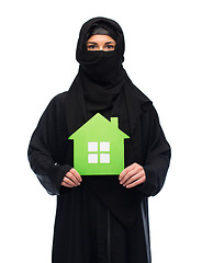 Image showing muslim woman in hijab with green house over white