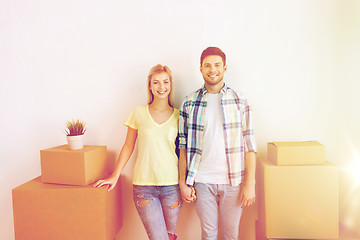 Image showing smiling couple with big boxes moving to new home