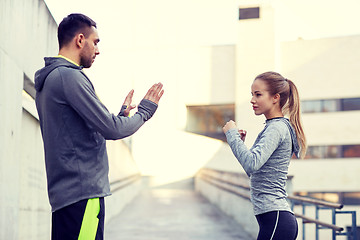 Image showing woman with coach working out strike outdoors