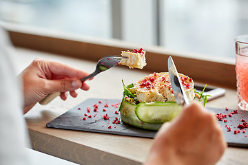 Image showing woman eating goat cheese salad at restaurant
