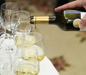 Image showing Pouring white wine