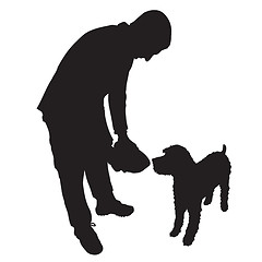 Image showing Man Feeding Dog