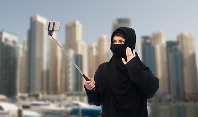 Image showing muslim woman in hijab taking selfie by smartphone