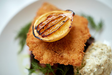 Image showing close up of fish salad with roasted lemon on plate