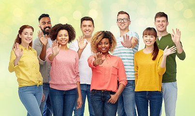 Image showing international group of happy people waving hand