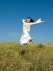Image showing Happy Jumping Girl above Field