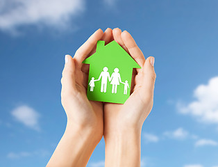 Image showing hands holding green house with family pictogram