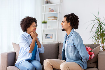 Image showing happy couple with bunch of flowers at home