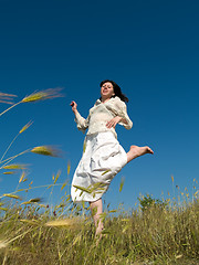 Image showing Happy Young Lady Runs Through Field