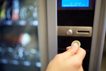 Image showing hand inserting euro coin to vending machine slot